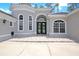 Charming home featuring a stucco exterior, arched entryway, and double doors at 1441 Foxtail Ct, Lake Mary, FL 32746