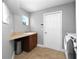Bright laundry room features tile floor, window, utility sink and a washer and dryer at 1441 Foxtail Ct, Lake Mary, FL 32746