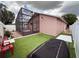 Backyard featuring screened in patio and artificial turf at 1470 Daniels Cove Dr, Winter Garden, FL 34787
