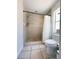 Bathroom featuring shower with neutral tile, mosaic tile shower floor, window, and standard toilet at 1470 Daniels Cove Dr, Winter Garden, FL 34787