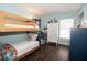 Charming bedroom with bunk beds, wood-look flooring, and white storage at 1470 Daniels Cove Dr, Winter Garden, FL 34787