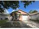 Charming one-story home featuring a well-maintained lawn, attached garage, and delightful landscaping at 1470 Daniels Cove Dr, Winter Garden, FL 34787