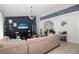 Comfortable living room featuring tile floors, plush sectional sofa, media console, and modern decor at 1470 Daniels Cove Dr, Winter Garden, FL 34787