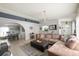 Inviting living room featuring tile flooring, sectional couch, open floorplan, and modern decor at 1470 Daniels Cove Dr, Winter Garden, FL 34787