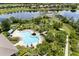 Community amenities including a sparkling pool, relaxing lounge area, and lush landscaping, viewed from above at 15500 Fountain Cove Ct, Winter Garden, FL 34787