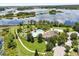 Stunning aerial perspective of the community's pool, mini-golf course, and picturesque lake views at 15500 Fountain Cove Ct, Winter Garden, FL 34787