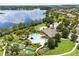 Beautiful aerial view of community pool and recreational facilities with a stunning lake backdrop at 15500 Fountain Cove Ct, Winter Garden, FL 34787