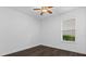 A bright bedroom featuring wood flooring, a ceiling fan, and a window with blinds at 15500 Fountain Cove Ct, Winter Garden, FL 34787