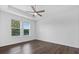 Bright bedroom with wood floors, tray ceiling, large windows and blinds at 15500 Fountain Cove Ct, Winter Garden, FL 34787