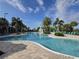 Large community pool with many lounge chairs and a splash fountain, surrounded by palm trees at 15500 Fountain Cove Ct, Winter Garden, FL 34787