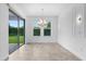 Dining room features tile floors, a modern light fixture, and sliding glass doors to the patio at 15500 Fountain Cove Ct, Winter Garden, FL 34787