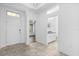 Spacious foyer leads to a bathroom and additional room, with natural light from transom window at 15500 Fountain Cove Ct, Winter Garden, FL 34787