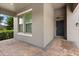Inviting home featuring a covered front porch and a stylish dark front door with elegant windows at 15500 Fountain Cove Ct, Winter Garden, FL 34787