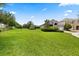 Expansive front lawn leading to a well-kept home with mature landscaping, offering great curb appeal at 15500 Fountain Cove Ct, Winter Garden, FL 34787
