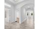 Hallway boasts an arched ceiling, tile flooring, and access to various rooms including the bathroom at 15500 Fountain Cove Ct, Winter Garden, FL 34787