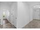 Bright hallway with doors leading to bedrooms and living areas, enhanced by natural light at 15500 Fountain Cove Ct, Winter Garden, FL 34787