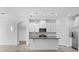 Bright kitchen features white cabinets, stainless steel appliances, granite counters and tiled backsplash at 15500 Fountain Cove Ct, Winter Garden, FL 34787