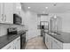 Modern kitchen features granite countertops, stainless steel appliances, and ample cabinet space for storage at 15500 Fountain Cove Ct, Winter Garden, FL 34787