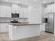 Modern kitchen with white cabinets, granite countertops, and stainless steel appliances, ready for cooking at 15500 Fountain Cove Ct, Winter Garden, FL 34787