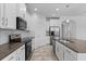 Well-equipped kitchen with stainless steel appliances, granite countertops, and white cabinets for ample storage at 15500 Fountain Cove Ct, Winter Garden, FL 34787