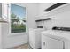 Bright laundry room featuring a front load washer and dryer at 15500 Fountain Cove Ct, Winter Garden, FL 34787
