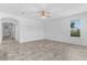 Open living room with large window and ceiling fan, featuring tile flooring at 15500 Fountain Cove Ct, Winter Garden, FL 34787