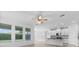 Open-concept living space with large windows, tile flooring, and a modern kitchen, perfect for Gathering gatherings at 15500 Fountain Cove Ct, Winter Garden, FL 34787