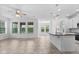 Bright living space with large windows, tile floors, and a kitchen island, perfect for entertaining at 15500 Fountain Cove Ct, Winter Garden, FL 34787