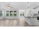 Open living space with tile floors, large windows and kitchen island with granite countertops at 15500 Fountain Cove Ct, Winter Garden, FL 34787
