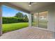 Paver patio with fan and sliding door, leading to a lush green yard, perfect for outdoor enjoyment at 15500 Fountain Cove Ct, Winter Garden, FL 34787