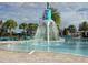 Community pool with fountain centerpiece, blue lounge chairs and tables on the deck at 15500 Fountain Cove Ct, Winter Garden, FL 34787