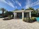 Poolside pavilion offering shade and seating, surrounded by decorative landscaping and greenery at 15500 Fountain Cove Ct, Winter Garden, FL 34787