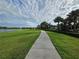 Scenic community walking path lined with palm trees and lush green space, ideal for outdoor recreation at 15500 Fountain Cove Ct, Winter Garden, FL 34787