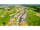 Breathtaking aerial view of a community near a golf course, displaying lush greenery and roadways at 15942 Vetta Dr, Bella Collina, FL 34756