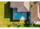 Aerial view of a sparkling pool and patio next to a house with tile roof and green landscaping at 15942 Vetta Dr, Bella Collina, FL 34756
