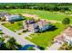 Beautiful aerial shot of a house, showcasing the well-maintained landscaping and golf course views at 15942 Vetta Dr, Bella Collina, FL 34756
