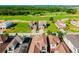 Expansive aerial view showing homes nestled in a community with golf course surroundings at 15942 Vetta Dr, Bella Collina, FL 34756
