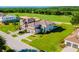 Stunning aerial view of a home with lush greenery and a golf course in the background at 15942 Vetta Dr, Bella Collina, FL 34756