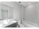 Well-lit bathroom with a gray vanity, white countertops, and a bathtub-shower combo at 15942 Vetta Dr, Bella Collina, FL 34756