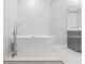 Bright bathroom with modern tub, sleek shower, and gray vanity at 15942 Vetta Dr, Bella Collina, FL 34756
