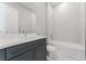 Bright bathroom featuring a gray vanity with white countertop, modern fixtures, and a combined shower and tub at 15942 Vetta Dr, Bella Collina, FL 34756