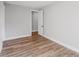 Clean bedroom showcasing wood-look flooring, and a door leading to another room at 15942 Vetta Dr, Bella Collina, FL 34756