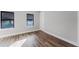 Inviting bedroom with wood-style flooring, great natural light from windows with blinds, and a modern aesthetic at 15942 Vetta Dr, Bella Collina, FL 34756