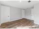 Bright bedroom highlighting modern lighting, wood-look flooring, and multiple doors for easy access at 15942 Vetta Dr, Bella Collina, FL 34756