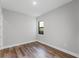 Bedroom with wood flooring and window, offering a bright and airy space at 15942 Vetta Dr, Bella Collina, FL 34756