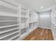 A large walk-in closet with custom shelving and drawers at 15942 Vetta Dr, Bella Collina, FL 34756