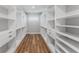 Large walk-in closet with custom shelving and drawers for ample storage at 15942 Vetta Dr, Bella Collina, FL 34756