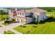 View of beautiful two-story house featuring a tile roof, an attached two-car garage, and green lawn at 15942 Vetta Dr, Bella Collina, FL 34756