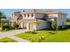 Beautiful two-story home with a tile roof, a two-car garage, and mature landscaping at 15942 Vetta Dr, Bella Collina, FL 34756