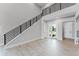 Bright foyer featuring soaring ceilings, modern black railings, and stylish tile flooring at 15942 Vetta Dr, Bella Collina, FL 34756